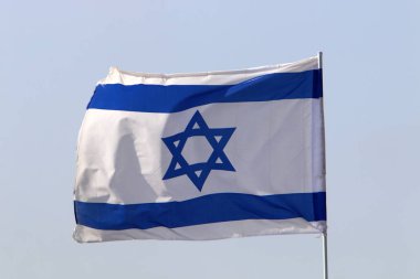 blue and white with the star of david the flag of Israel develops in the wind  clipart