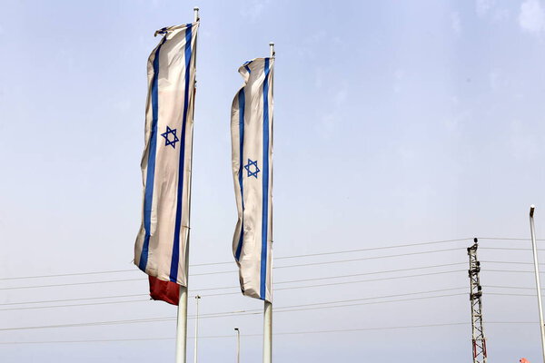 flag fluttering in the wind , the flag is mounted on the mast and is a symbol of the state 