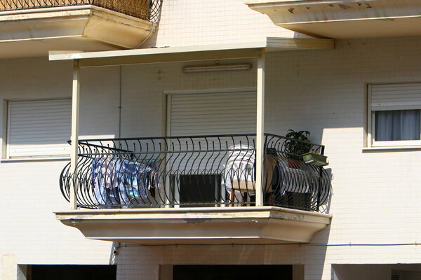 The balcony in architecture is a platform with a railing, mounted on beams protruding from the wall.