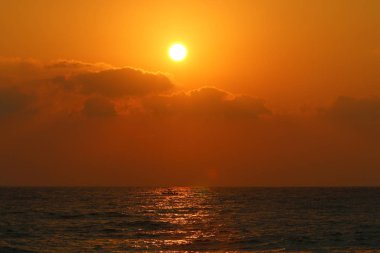 Kuzey İsrail'de Akdeniz'de ufukta güneş batıyor, gün bitiyor ve gece çöküyor. 