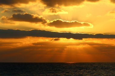 Kuzey İsrail'de Akdeniz'de ufukta güneş batıyor, gün bitiyor ve gece çöküyor. 