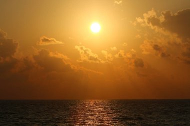 Kuzey İsrail'de Akdeniz'de ufukta güneş batıyor, gündüz bitiyor ve gece çöküyor 