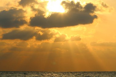 Kuzey İsrail'de Akdeniz'de ufukta güneş batıyor, gündüz bitiyor ve gece çöküyor 