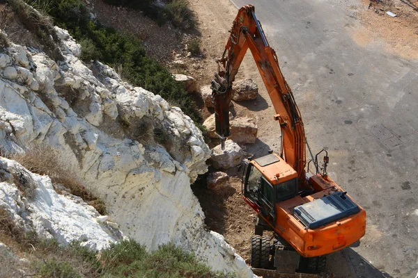 Büyük bir ekskavatör Akdeniz kıyısında İsrail'de bir şantiyede çalışır 