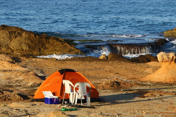camping tent on the deserted coast of the Mediterranean Sea in the north of Israel