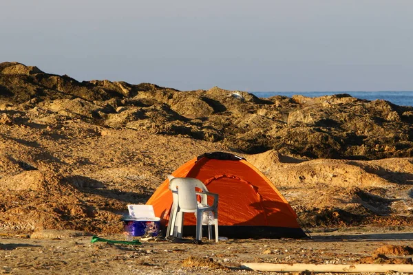 camping tent on the deserted coast of the Mediterranean Sea in the north of Israel