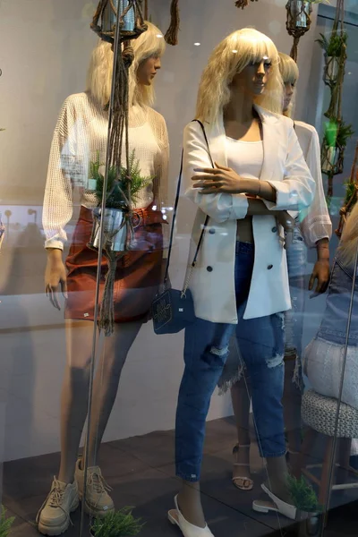 High end mannequins in a Gucci window display showing both male and female  mannequins.
