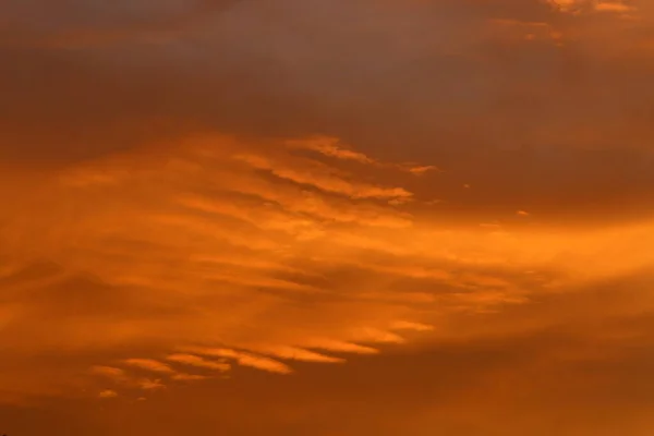 Fiery red sky lighting over the horizon at sunset. The sun sets over the horizon in the Mediterranean Sea in northern Israel