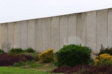 Taş ve betondan yapılmış yüksek duvar. Taş duvar dokusu 