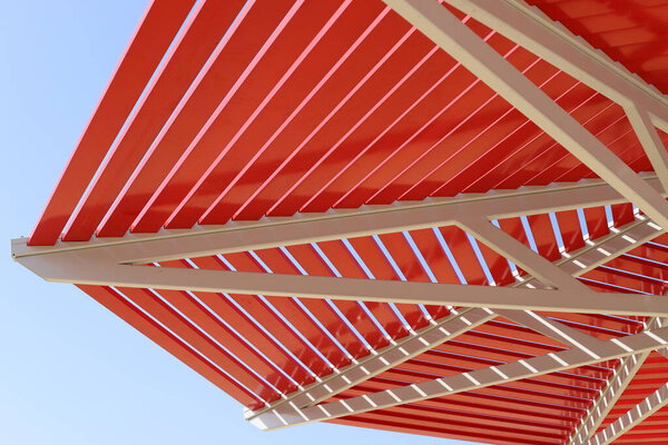A canopy from the hot sun in a city park by the sea in Israel. Hot summer in Israel 
