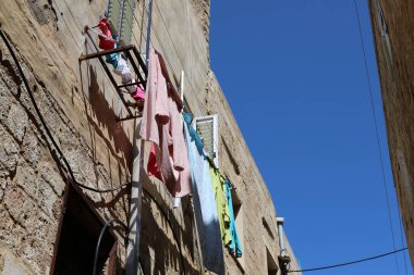 Pencere ve balkonlarda çamaşır ipleri kuruyor. İsrail 'deki konutların mimari detayları 
