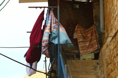 Pencere ve balkonlarda çamaşır ipleri kuruyor. İsrail 'deki konutların mimari detayları 