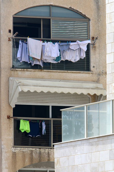 Clothesline drying on windows and balconies. Architectural details of housing in Israel