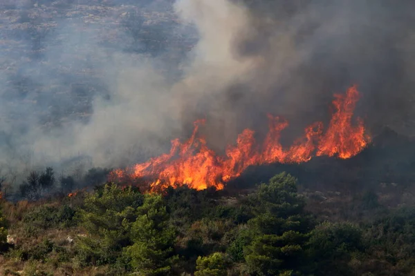 a United Nations helicopter extinguishes a fire on the Israel-Lebanon border