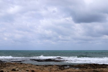 Kuzey İsrail 'deki Akdeniz üzerinde mavi bir gökyüzü üzerinde yağmur bulutları 