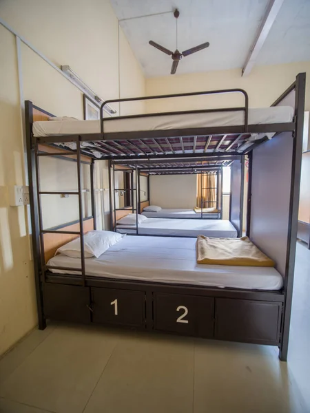 Empty room for a cheap hostel with bunk beds in India.