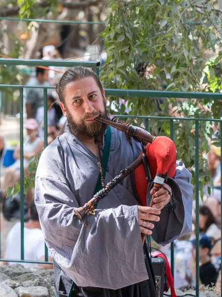 Jerusalem, Israel, September 29, 2018 : Participant of the festival in the traditional medieval dress plays music on the bagpipes at the annual festival `Jerusalem Knights`