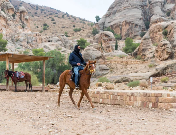 Wadi Musa, Ürdün, 06 Aralık 2018: Bedevi önde gelen Petra - Ürdün Wadi Musa şehirde Nabatean krallığının başkenti yol boyunca bir Arap atı at binme