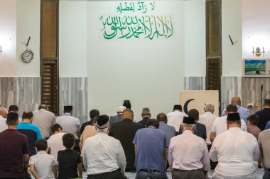 Muslim believers pray in prayer room of the Ahmadiyya Shaykh Mahmud mosque in Haifa city in Israel clipart