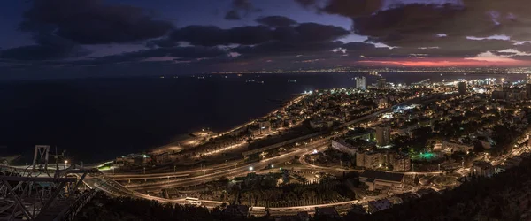 stock image Night view in the light of lanterns from Mount Carmel to the downtown and the seaport of Haifa located on the shores of the Mediterranean Sea