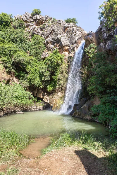 Mountain Saar Falls with cold and crystal clear water descends from a crevice in the mountains of the Golan Heights in Israel.