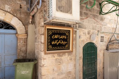 Kudüs, İsrail, 13 Haziran 2020: Arapça dekoratif yazıt - bu eve girerken, peygambere dua eder- eski Kudüs, İsrail 'deki Arap Mahallesi' ndeki bir yerleşim yerinin duvarında asılı.