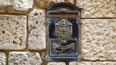 Mdina, Malta, 04 July, 2013 : Metal panel of mailbox in wall of old stone house in historical part of Mdina old city in Malta