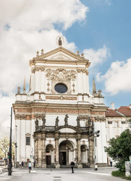 Prague, Czech Republic, May 15, 2024 : Facade with statues of saints of  St Ignatius Church on the Charles Square Street in the Pragues Old Town in Czech Republic
