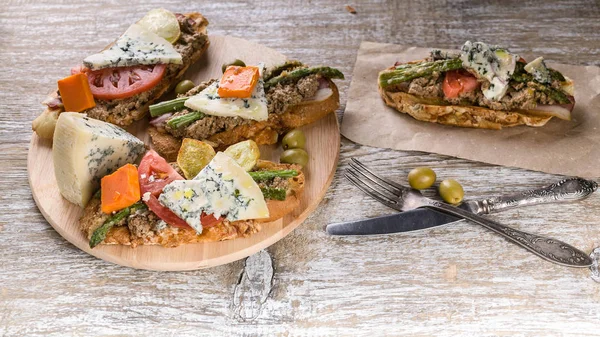 Food banner. Italian sandwiches with mushroom pate, vegetables and cheese. Mediterranean traditional cuisine. Close-up