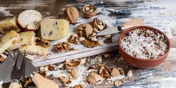 Food banner. Various types of cheese, nuts and spices on a wooden background. Close-up. Top view