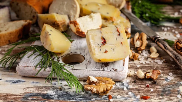 Food banner. Various types of cheese, nuts and spices on a wooden background. Close-up. Top view