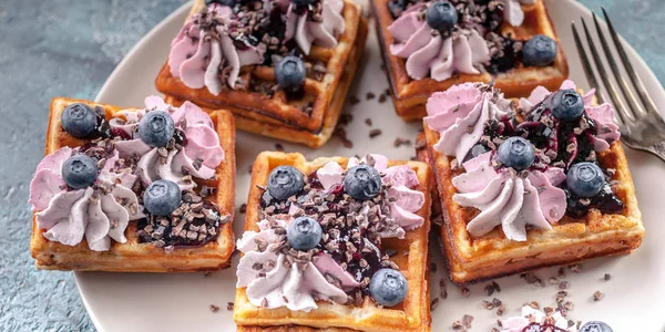 Food banner. Homemade Belgian waffles with cream, jam, blueberry and mint leaves. Delicious Dessert