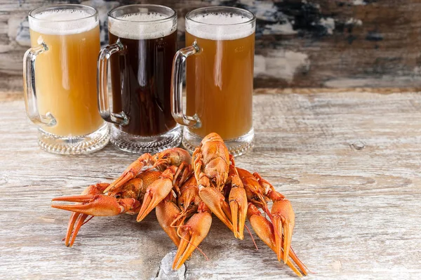 Beer and a boiled crayfishes on a wooden background