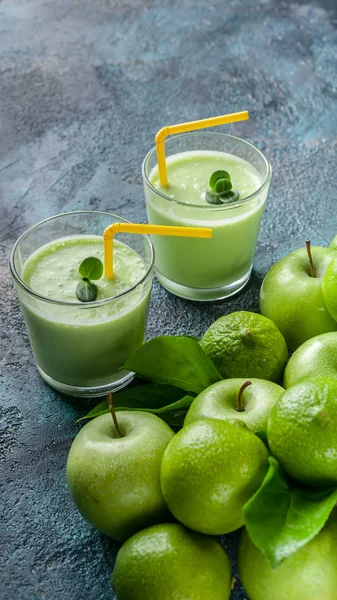 Vertical food banner smoothies apples and limes on a dark blue concrete background. Detox programm