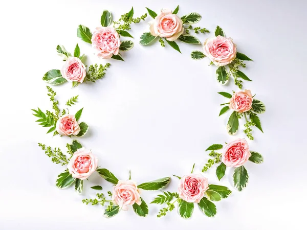 Round frame flower pattern of rosebuds on a white background.
