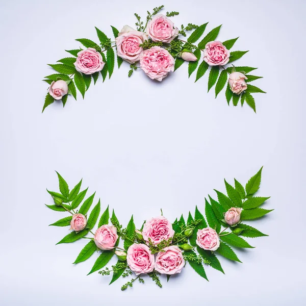 Frame of flowers: rose, lilac, rowan leaves on a white background. Floral pattern. Copy space for text