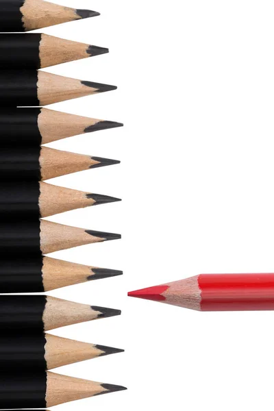 Red pencil among black ones on white background — Stock Photo, Image