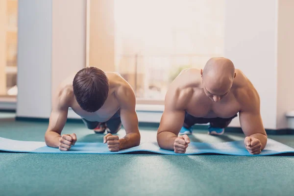 Dwóch mężczyzn będzie wykonywać trening fitness w siłowni — Zdjęcie stockowe