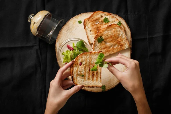 Fried toast with a can of pate on a wooden tray