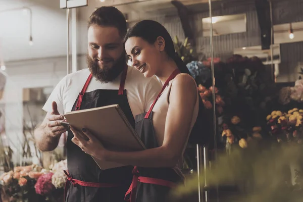 Portrait of smiling florists man and woman