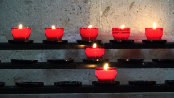 Ljusen brinna i ljusstakar på hyllorna i templet — Stockvideo