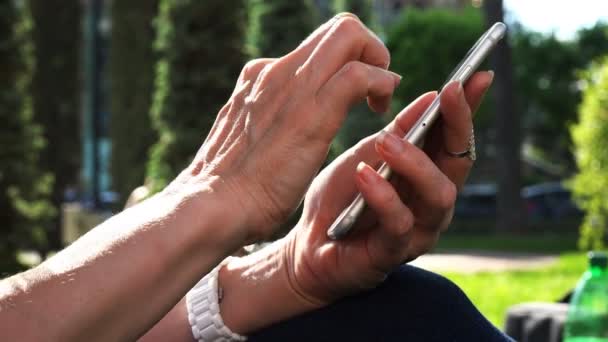 The hand of a white man with fingers works on the phones sensor panel — Stock Video