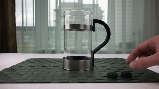 Mens hand puts pressed tea in the kettle — Stock Video