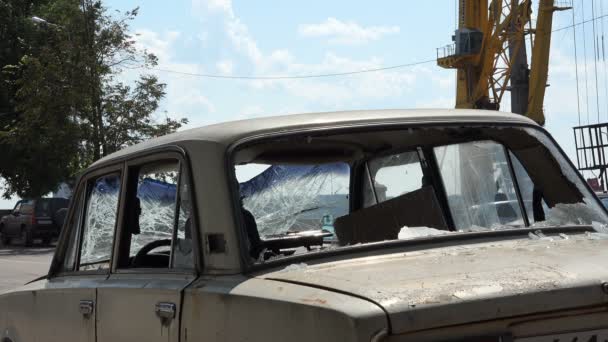 Raked αυτοκίνητο με σπασμένα παράθυρα στο οδόστρωμα — Αρχείο Βίντεο