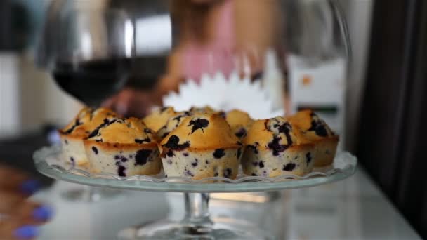 Een vrouwelijke hand de klep van de lade van een glazen liften en neemt een cupcake — Stockvideo