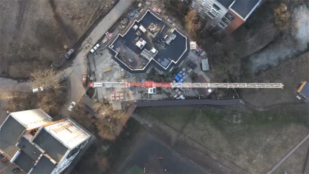 Boom grúa sobre el techo de la casa en construcción. Vista superior — Vídeo de stock