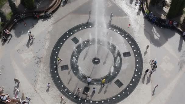 La gente si siede sulle panchine e oscilla su un'oscillazione ad una fontana di canto — Video Stock