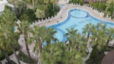 the hotel has a swimming pool with sun loungers for guests. View from above