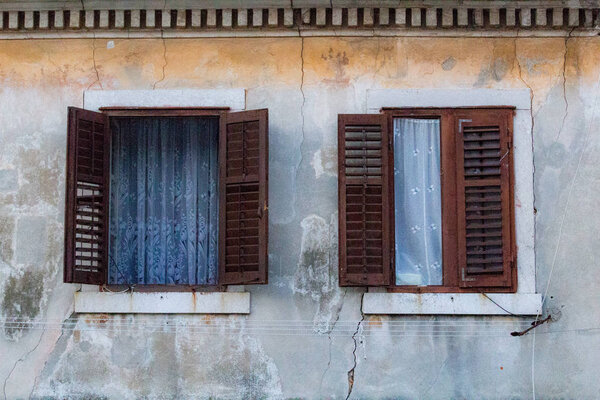 Zadar, Croatia - July 23, 2018: Windows and curtains on a facade of a typical buiding in the old town