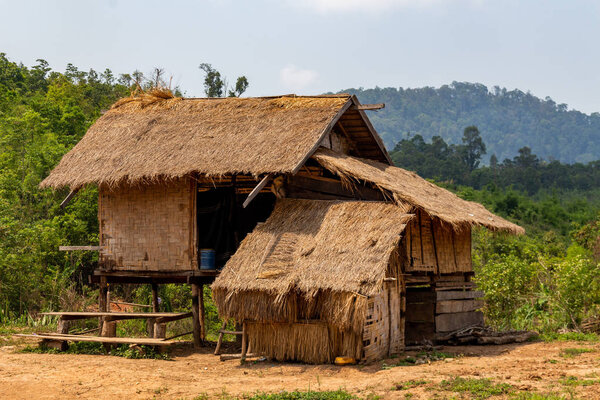 Thakhek, Laos - April 20, 2018: Bamboo house in a remote rural area surrounded by green in Laos